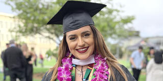 Maria Membrila holding flowers after graduating.