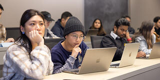 Students in classroom looking at laptops