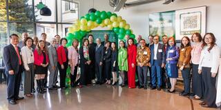 Group of people gathered in front of balloon arch at the Center for Asian Pacific Studies event