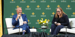 Kevin Costner on stage at the Silk Speaker Series during CelebrateUSF weekend with Brenna Malloy