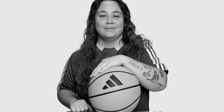 Rachel Cain holding a basketball with the adidas logo
