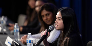 Joleena Marshal speaking on a with a microphone