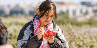 Student jots notes in her journal in the Bayview neighborhood of San Francisco