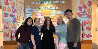 group of event attendees smile for photo