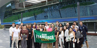 USF students in Australia holding up San Francisco Dons banner