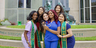 Nursing students posing on campus.