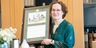 Alice Kaswan holding a plaque 