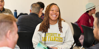 student sitting with a group during an event
