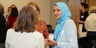 Zarah Goliaei in conversation with two others.
