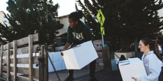 Students load boxes in a truck