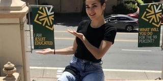 Mercy Bertero on the USF steps in front of USF banners