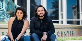 two usf students in front of gleeson library