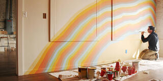 Eric Hongisto, assistant professor and director of USF’s Fine Arts program, paints a wall in Alameda