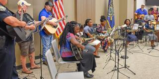 Kids play guitars in a group