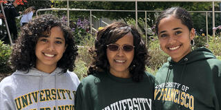 Mercy, left, and Merha Mehzun, with their mother in the center