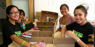 USF students package food in boxes for delivery to people living with HIV/AIDS and senior citizens in San Francisco's Tenderloin district.