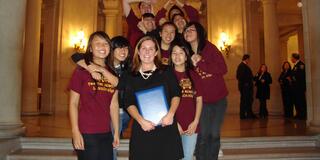 USF alumna Valerie Ziegler, MA ’04, named California Teacher of the Year, shown with group of students