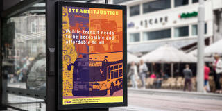 Bus stand with transit justice poster