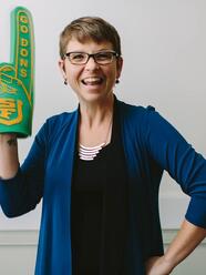 April Crabtree poses with styrofoam hand