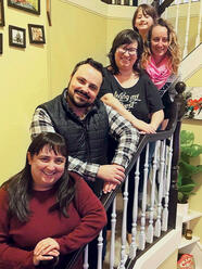 USF Alumni reunite on the staircase in one of their homes for a photograph