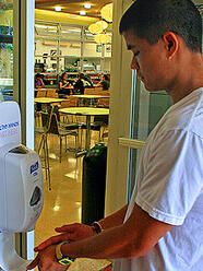 USF senior Gary Au using hand sanitizer