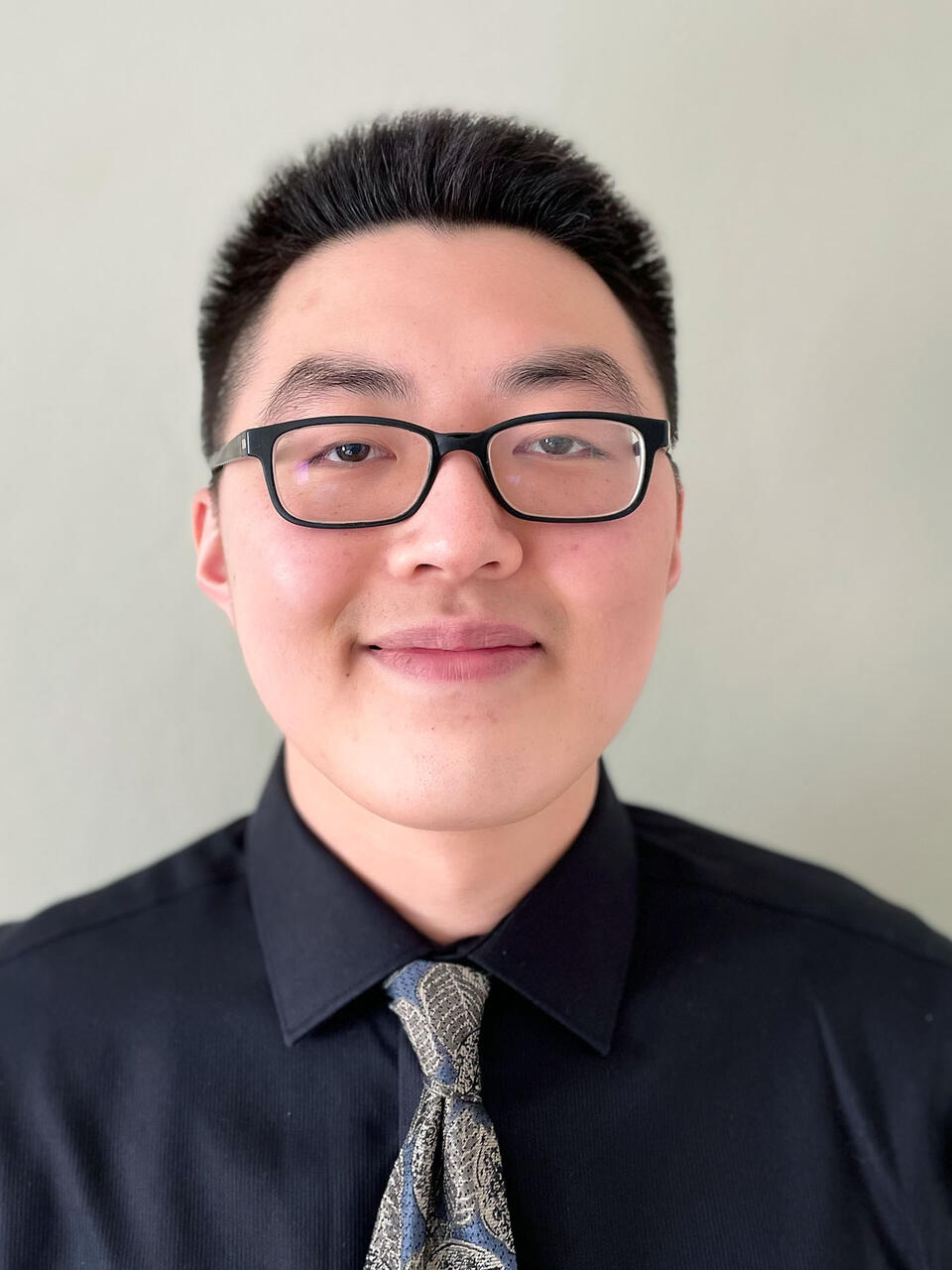 Student poses for photo wearing a tie