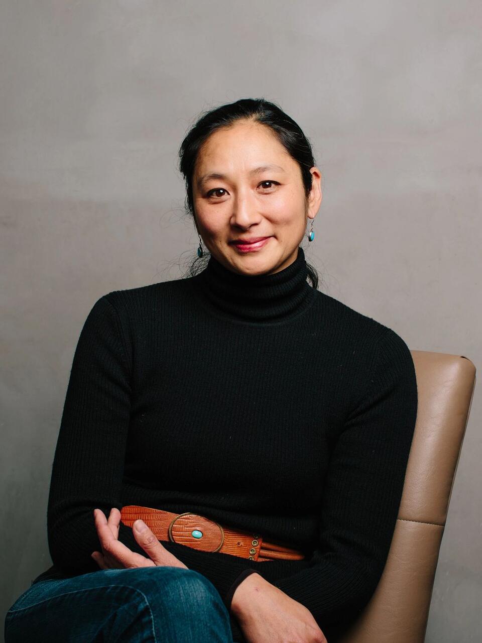 Hana Mori Bottger sits in chair