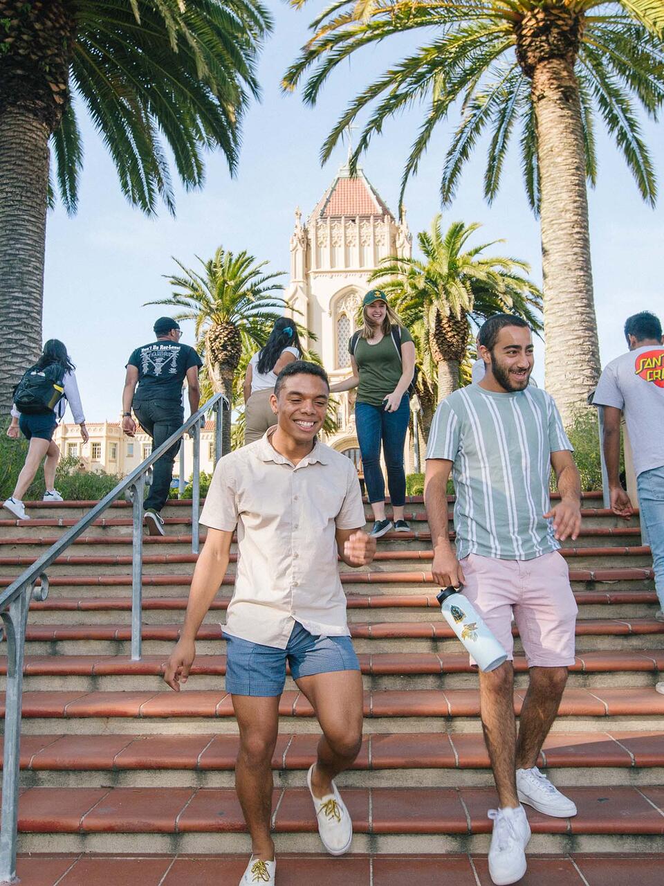 A number of students pass each other on the stairs leading to Lone Mountain.