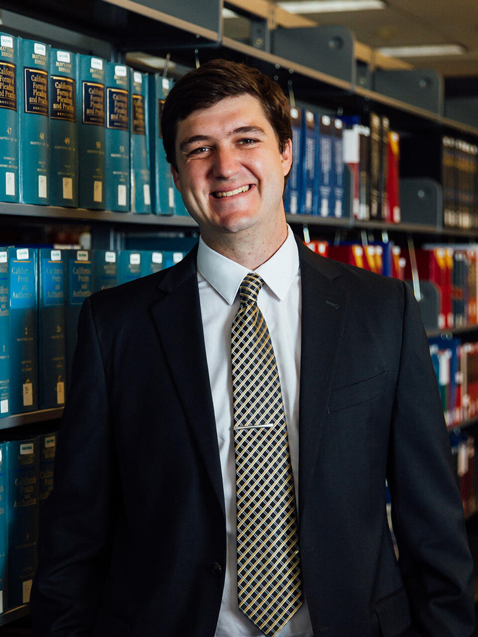Zach McCoy standing in library.
