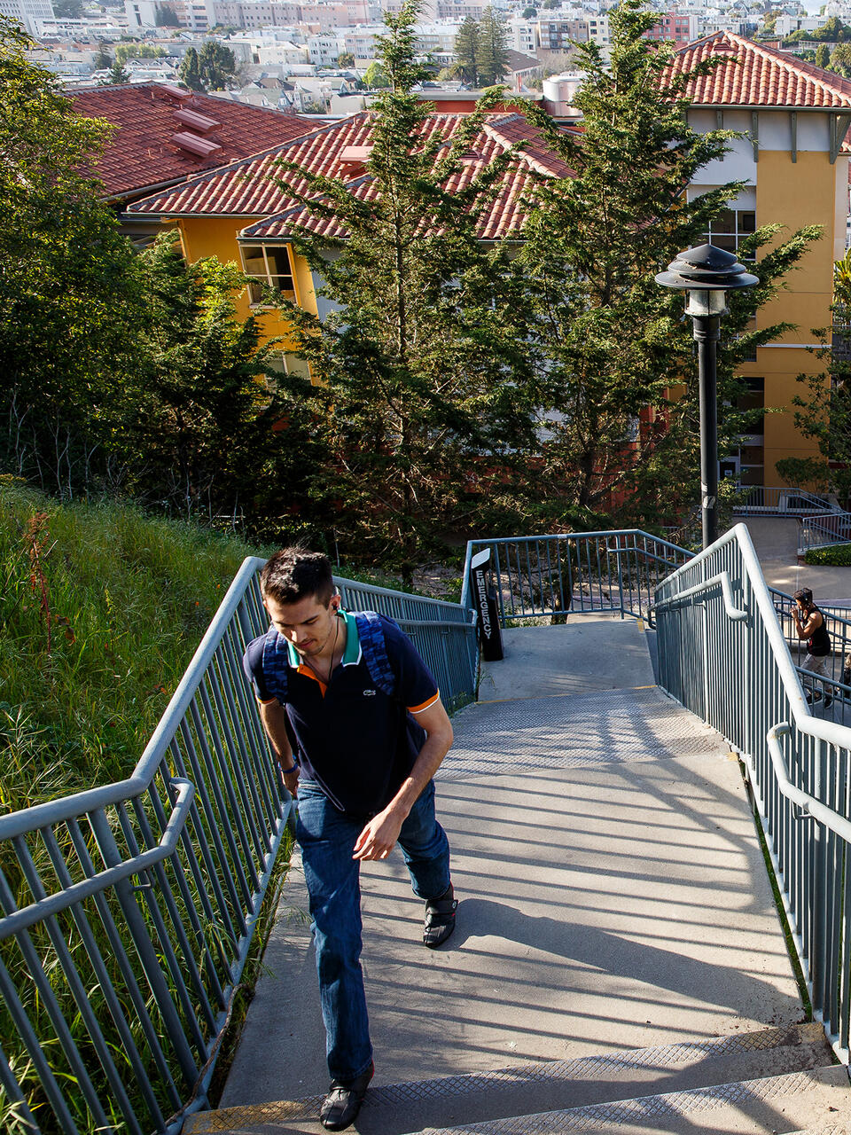 student walking up loyola village steps