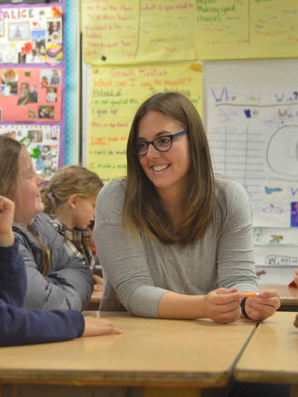 Student in a classroom of kids