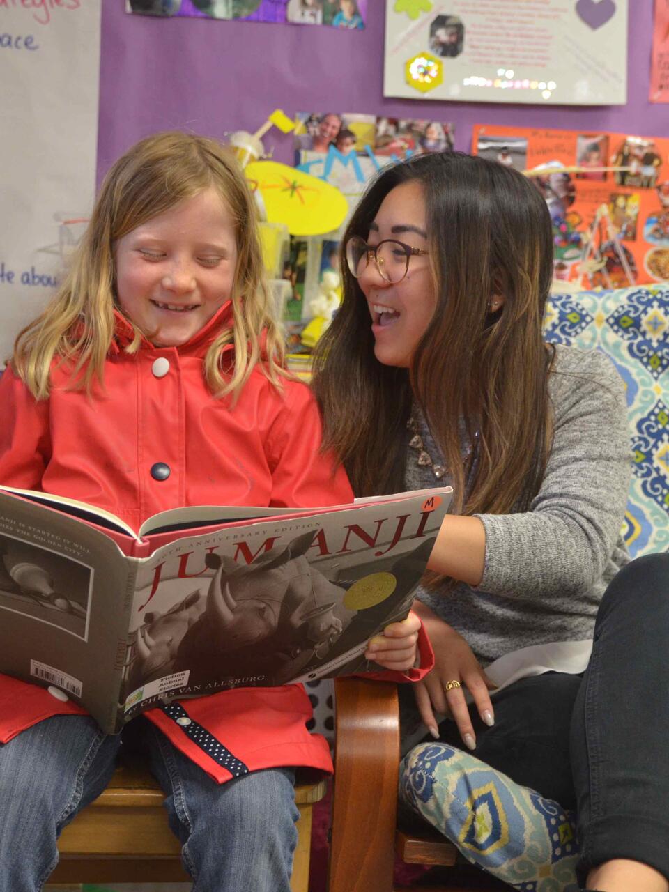 Student reading with a child