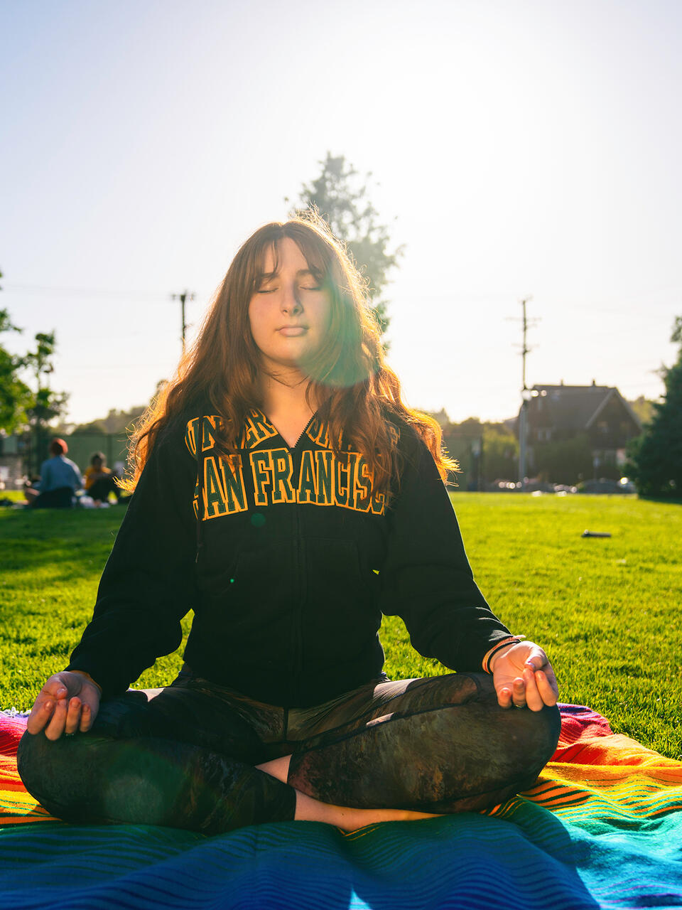 student meditating outside