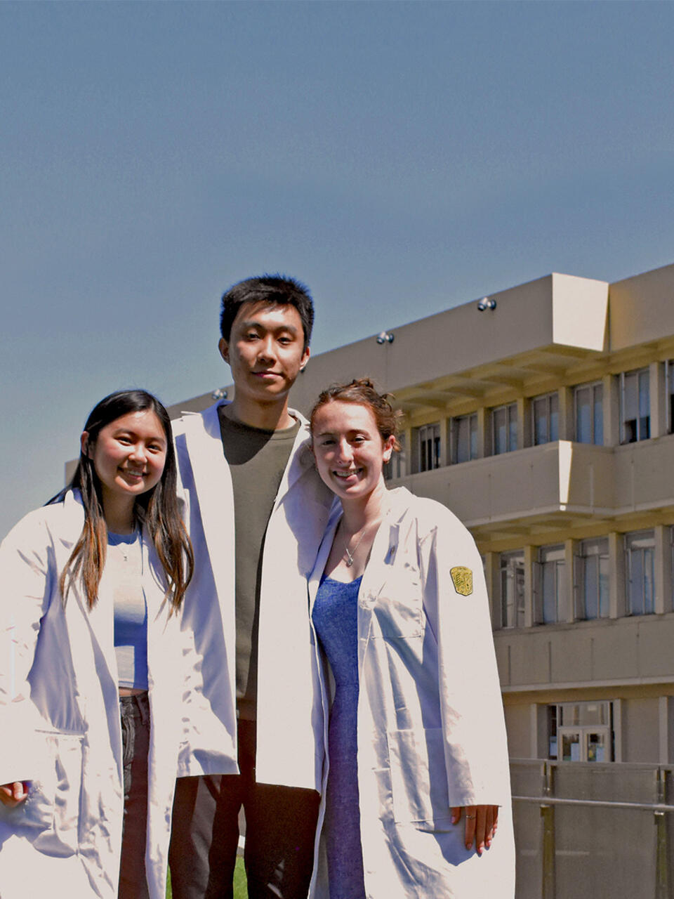 Three nursing students in lab coats