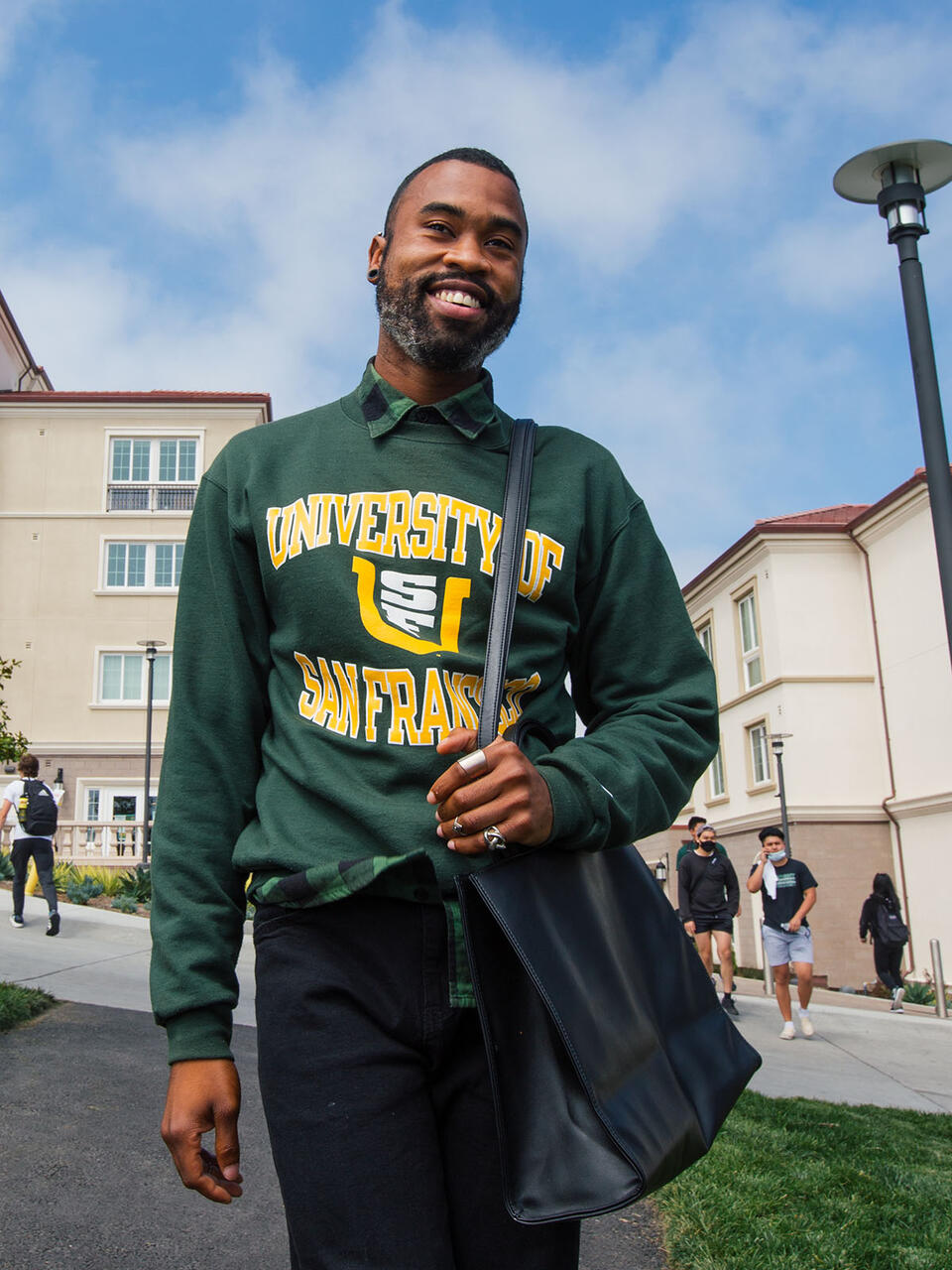 Student walks in front of Lone Mountain East dorm.