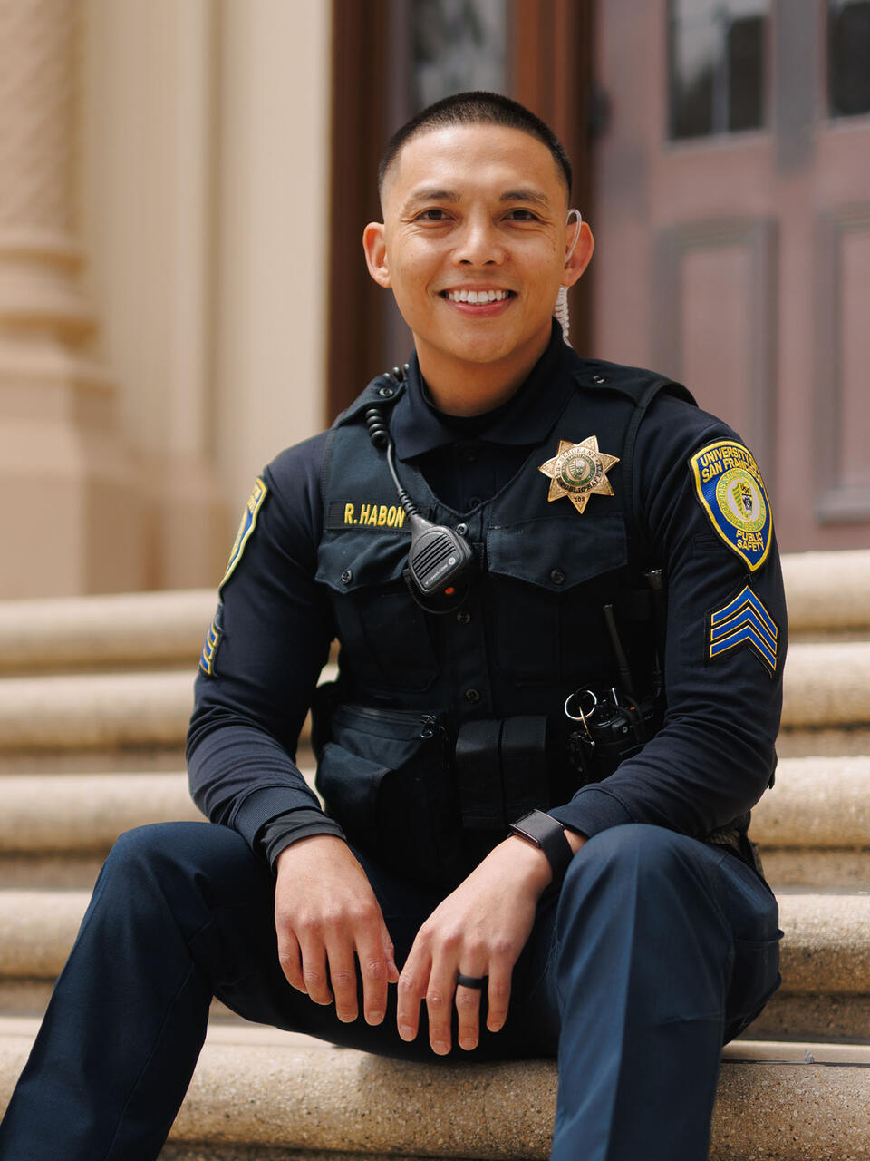 Public Safety officer seated on stairs