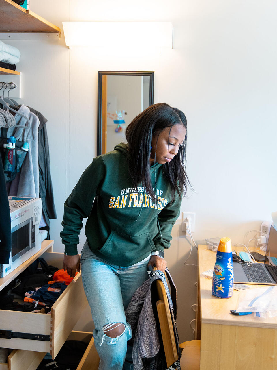 USF student unpacking in new dorm room
