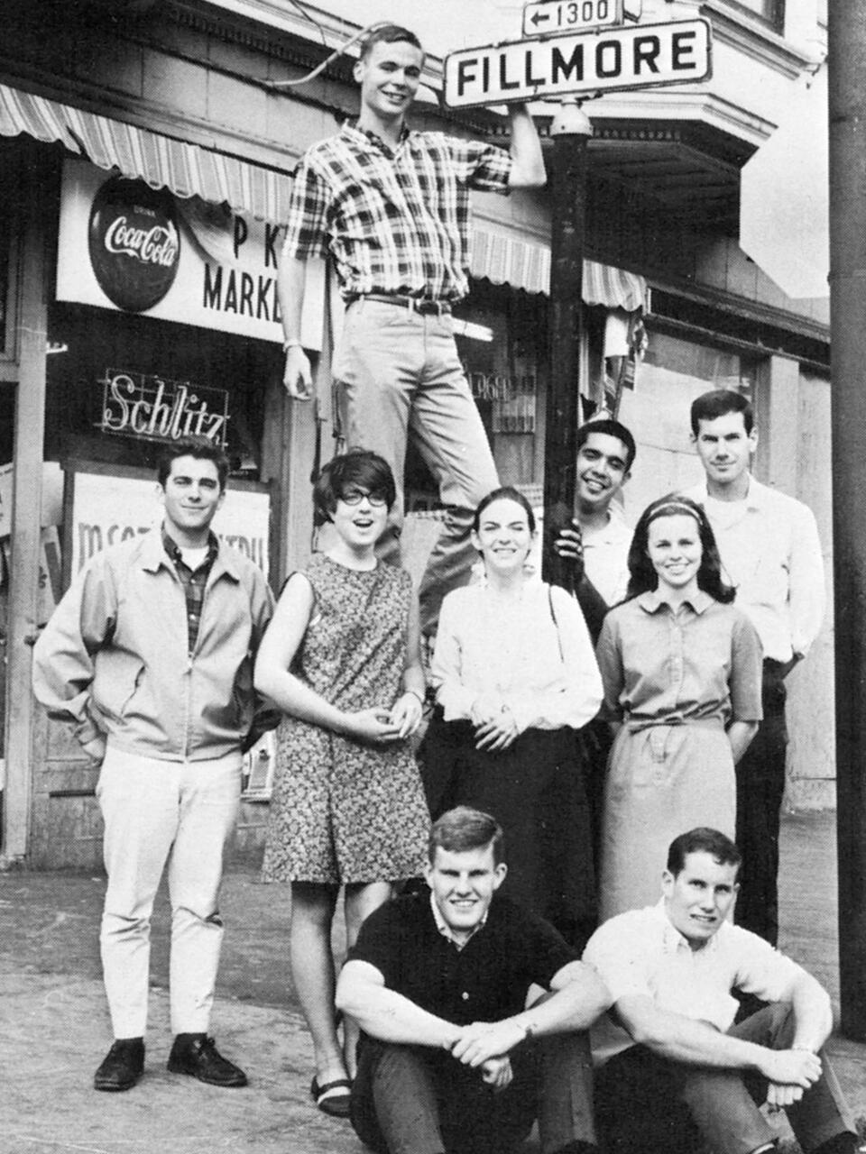 Students in 1962 pose near a street sign for Fillmore Street